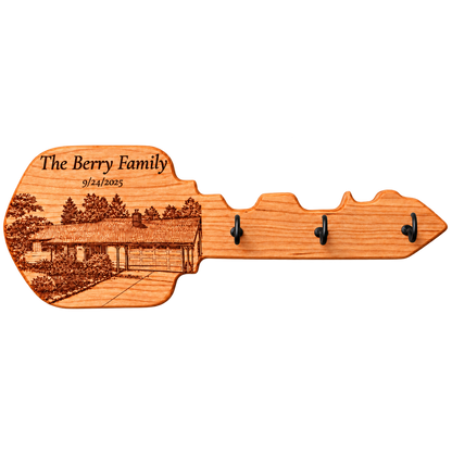 Key-shaped wood hanger with a personalized house portrait and hooks; example of custom work.