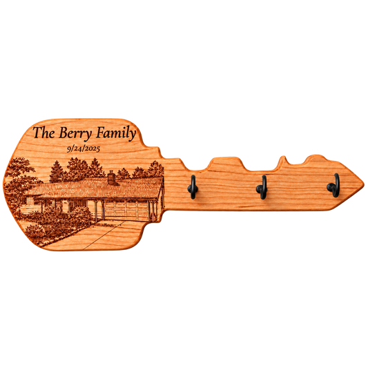 Key-shaped wood hanger with a personalized house portrait and hooks; example of custom work.