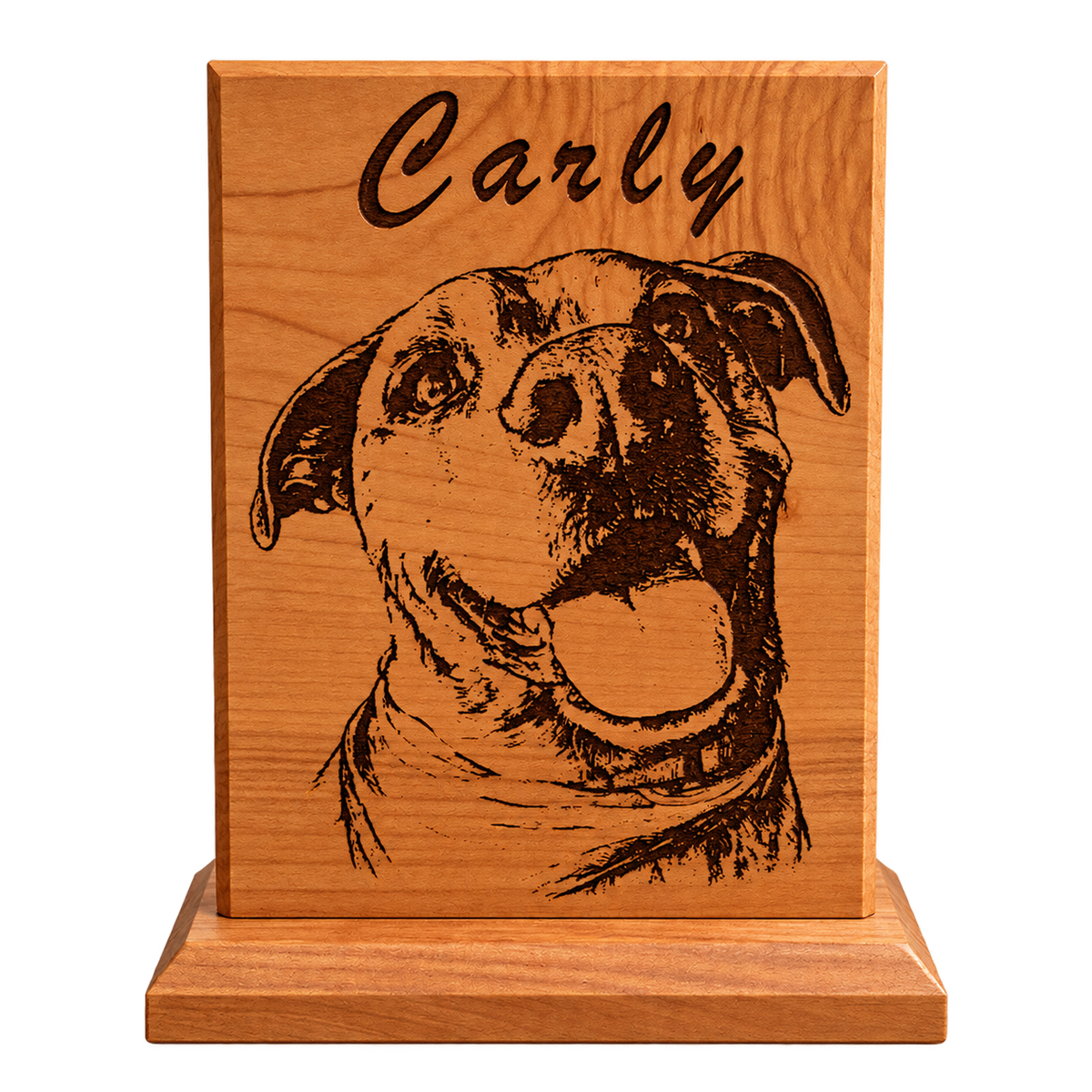 A personalized wooden plaque featuring a engraved portrait of a dog and the name 'Carly' at the top, displayed on a wooden stand on a desk.