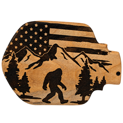 Design inspiration: Bigfoot with Flag and Mountain. Past-work example; choose your size and wood.